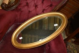 A gilt frame oval wall mirror, approx. 66 x 33cm