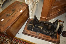 An Antique hand crank sewing machine, The Weaver, with wooden case