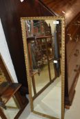 A gilt frame half length wall mirror