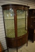 An impressive early 20th Century mahogany display cabinet in the classical style having tri