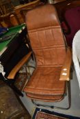 A vintage folding chrome and vinyl easy chair