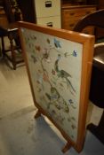 A large embroidered fire screen