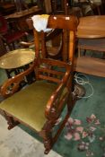 A 19th Century mahogany rocking chair having part spindle back