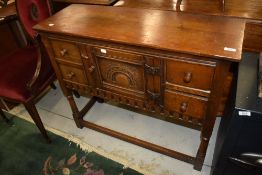 A reproduction oak sideboard of small proportions in the Titchmarsh and Goodwin style, width approx.