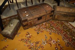 A set of three period travel trunks, graduated sizes, covered with horse or similar animal skin,