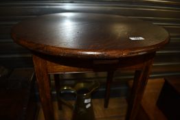 A circular topped oak occasional table, diameter approx. 51cm