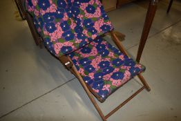 A vintage deck chair, having sun canopy