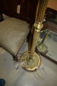 An antique brass standard lamp