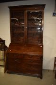 A 19th Century mahogany bureau bookcase, the upper section having wooden shelves behind astral