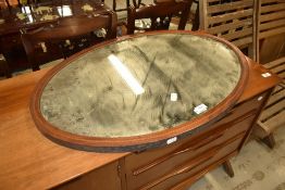 An Edwardian oval wall mirror