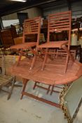 A garden table and chairs set , stained tea or similar