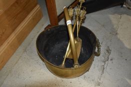 A brass coal helmet and companion stand