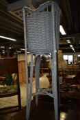 A modern basket on stand, painted grey