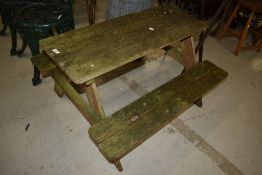 A rustic wooden garden picnic table, child's size
