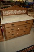 A Victorian stripped wash stand having marble top and tiled back