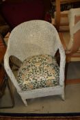 A Lloyd Loom or similar tub chair