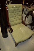 A 19th Century button back nursing chair having mahogany frame and later upholstery
