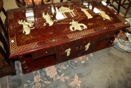 A modern rouge Chinoiserie coffee table, width approx. 122cm