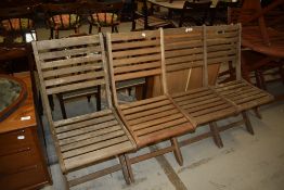 A set of four teak folding garden chairs