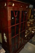 A modern rouge Chinoiserie display cabinet, width approx. 81cm