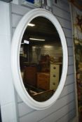 A classical style painted oval wall mirror
