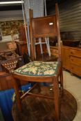 An Edwardian mahogany bedroom chair having inlay to solid back with tapered supports