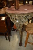 A traditional Britannia pub table having stripped wooden circular top