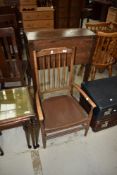 A late 19th or early 20th Century stained frame low seat chair having spindle frame