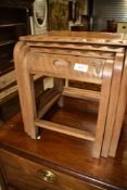 A vintage nest of three Oriental style tables, the smallest table having interesting integral