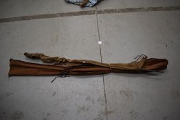 Two vintage fishing rods with sleeves.