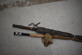 A vintage three piece split cane fly rod and Edgar Sealy live fibre fly rod in sleeves.