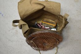 A canvas bag containing vintage fishing tackle