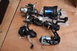 A selection of 6 fishing reels including Intrepid , Mitchell, Shakespear, Shimano, and a Fladen