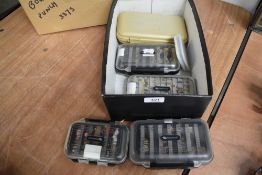 A selection of plastic fly fishing boxes containing hundreds of flies