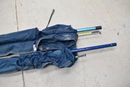 Two fishing rods in nylon cases.