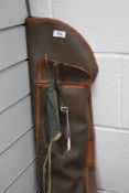 A fishing rod case containing split cane fly rod and carbon rod with spare tip and z rod rests.