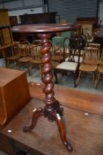A Victorian mahogany occasional table having twist column pedestal on triple legs