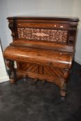 An interesting 19th Century mahogany pianette (73 keys) having fretwork back panel , and animalistic