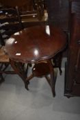 An early 20th Century mahogany occasional table having shaped top and undertier