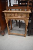 A reproduction golden oak side table in the period style, width approx. 61cm