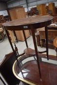 An early 20th Century mahogany kidney shaped occasional table having slender tapered inlaid legs