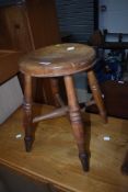 A traditional four splay legged milking style stool
