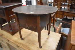 An early 20th Century oak sewing table