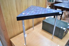 A vintage triangular occasional table , on chrome tapered legs