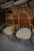 A pair of Ercol hoop and stick back carver chairs