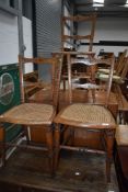 A set of three Victorian bedroom chairs having cane seats , part scumbled frame