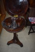 A William IV rosewood teapoy having internal caddies/mixing pots on fluted column and typical triple