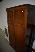 An early 20th Century oak wardrobe having internal drawers, labelled for Denby & Spinks, LEEDS,