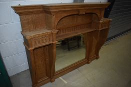 An Arts and Crafts style golden oak over mantel mirror