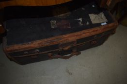 A vintage part leather travel luggage trunk , bearing various vintage labels including British